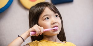 little girl brushing teeth